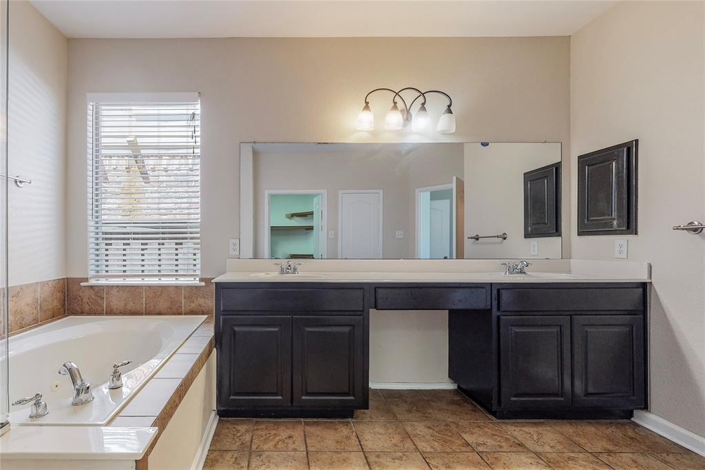 2855 Coteau Way Dallas, TX 75227 - Photo 21 of 35 a spacious bathroom with a granite countertop bathtub sink and mirror