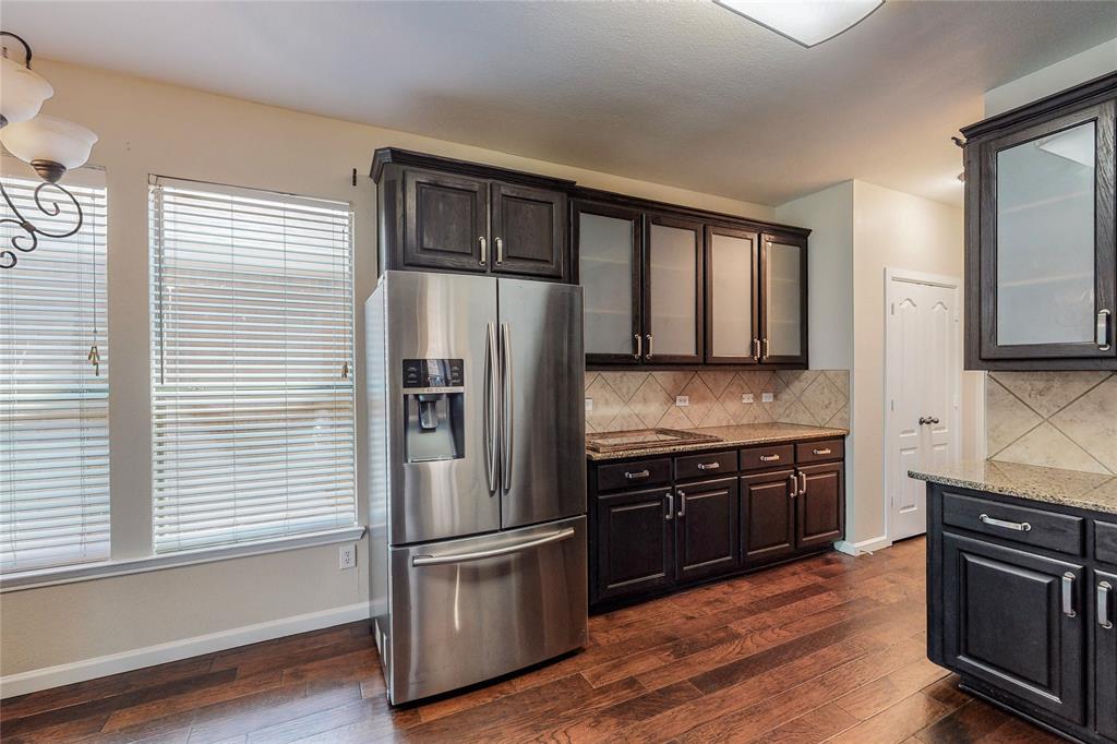 2855 Coteau Way Dallas, TX 75227 - Photo 24 of 35 a kitchen with stainless steel appliances granite countertop a refrigerator stove and sink