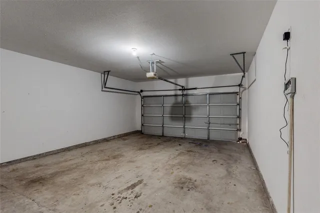 a large kitchen with granite countertop a refrigerator a sink and a stove