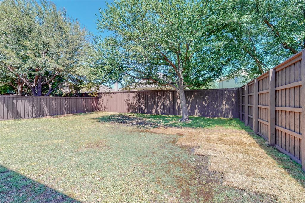 2855 Coteau Way Dallas, TX 75227 - Photo 30 of 35 a view of a backyard with wooden fence