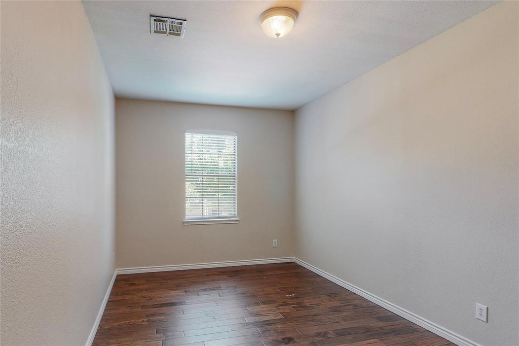 2855 Coteau Way Dallas, TX 75227 - Photo 9 of 35 an empty room with wooden floor and windows