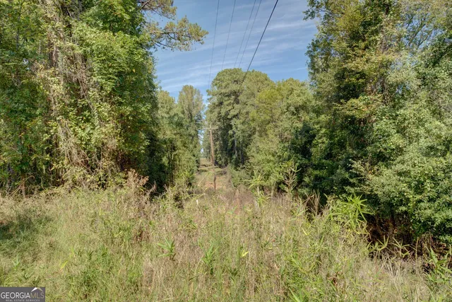 a view of a large kitchen with wooden floor and iron stairs