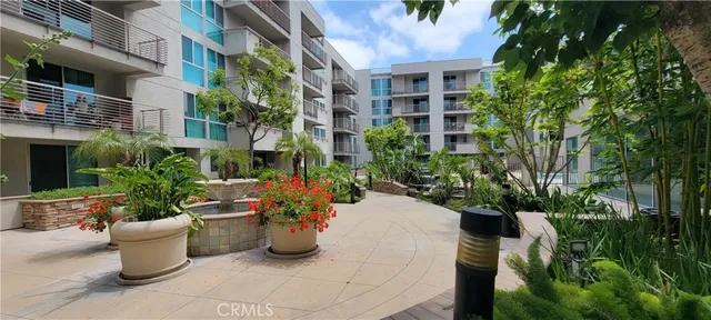a view of a patio with plants and chairs and flower plants