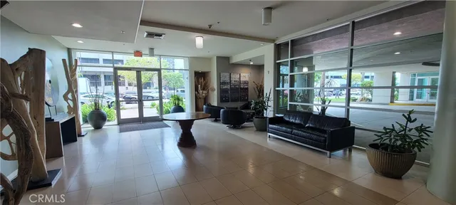 a living room with furniture a large window and a clock