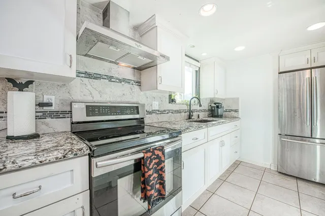 a spacious bedroom with a bed and a dresser