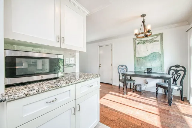 a living room with furniture fireplace and a large window