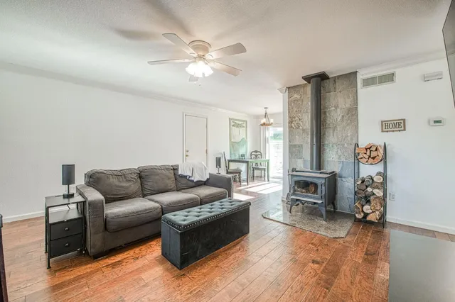 a front view of a house with a garden and seating space