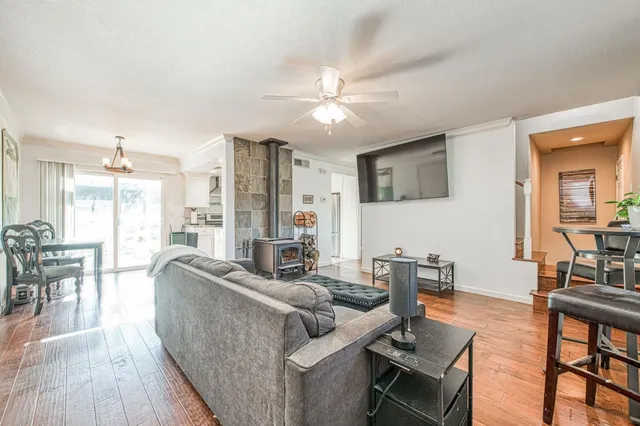 a dining room with furniture a chandelier and wooden floor