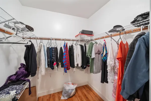 a view of walk in closet with clothes