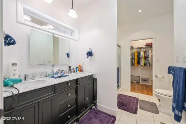 a spacious bathroom with a double vanity sink and a mirror