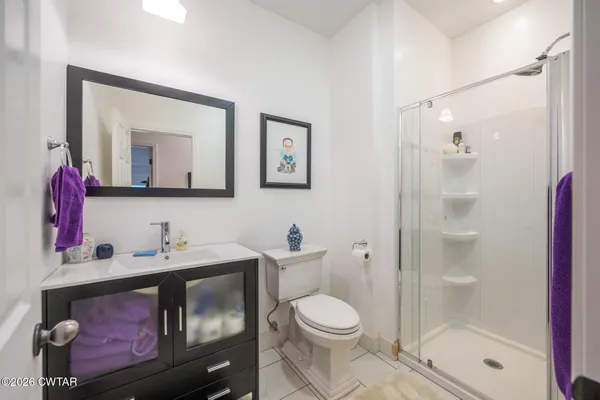 a bathroom with a toilet sink and shower