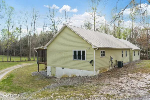 a view of a house with a yard and wooden fence