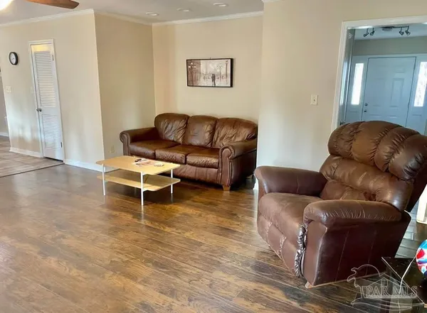a view of an empty room with closet and a window