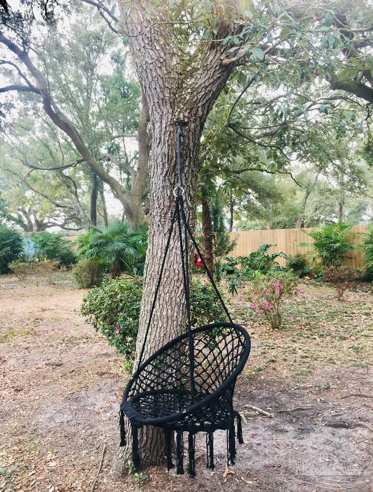 5705 Admiral Doyle Road Pensacola, FL 32506 - Photo 27 of 32 a view of a roof deck with chair and wooden fence
