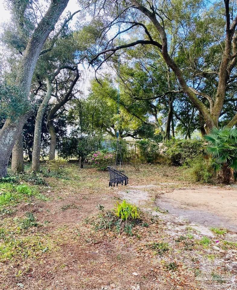5705 Admiral Doyle Road Pensacola, FL 32506 - Photo 28 of 32 a backyard of a house with a yard and outdoor seating