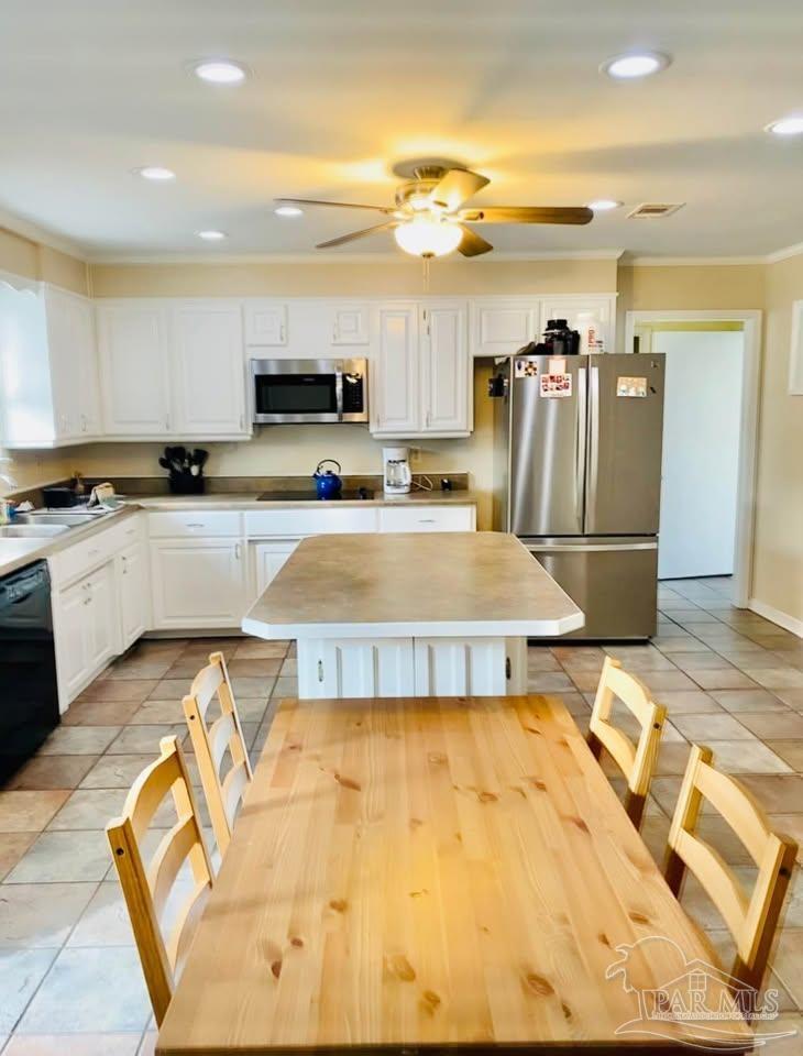 5705 Admiral Doyle Road Pensacola, FL 32506 - Photo 32 of 32 a view of a kitchen with kitchen island granite countertop a refrigerator and a stove top oven