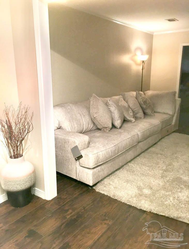 5705 Admiral Doyle Road Pensacola, FL 32506 - Photo 5 of 32 a living room with a couch and a table