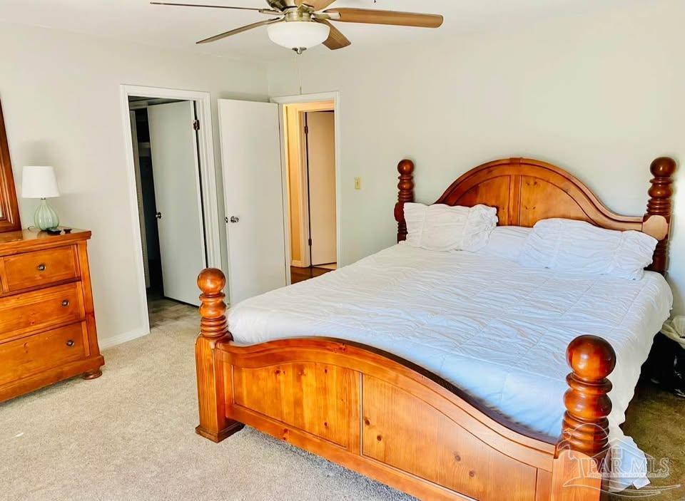 5705 Admiral Doyle Road Pensacola, FL 32506 - Photo 8 of 32 a bedroom with a bed and a chandelier
