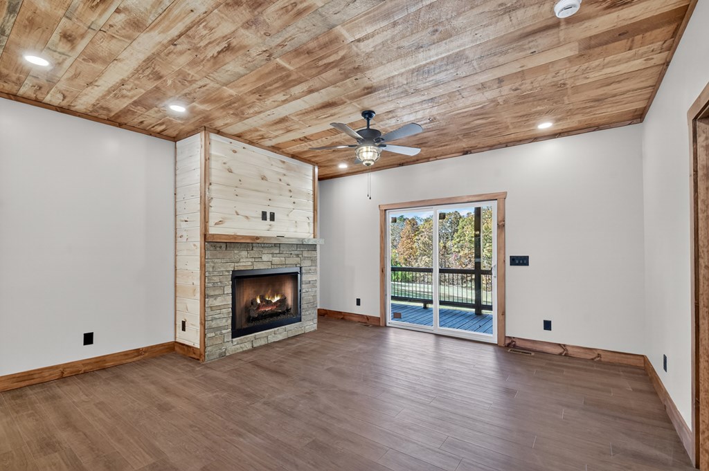 524 Old Highway Blue Ridge, GA 30513 - Photo 13 of 34 a view of an empty room with a fireplace and a window