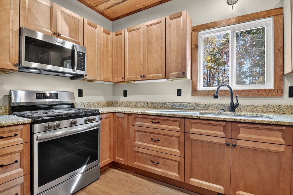 524 Old Highway Blue Ridge, GA 30513 - Photo 10 of 34 a kitchen with granite countertop a stove a sink and a microwave