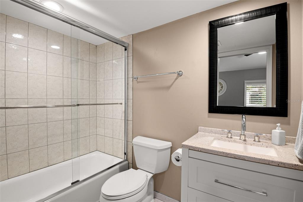 529 Sandy Hook Road Treasure Island, FL 33706 - Photo 36 of 55 a bathroom with a granite countertop sink a toilet and shower