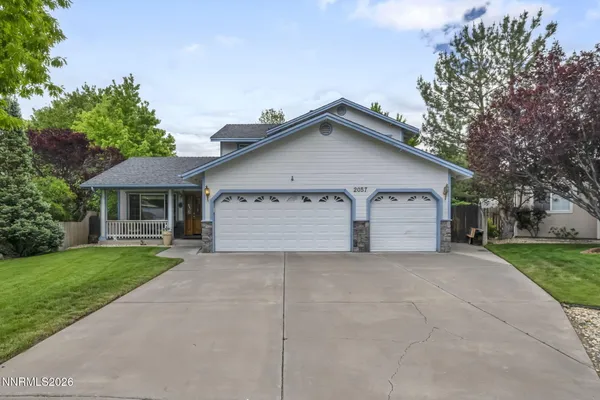 a front view of a house with yard and green space