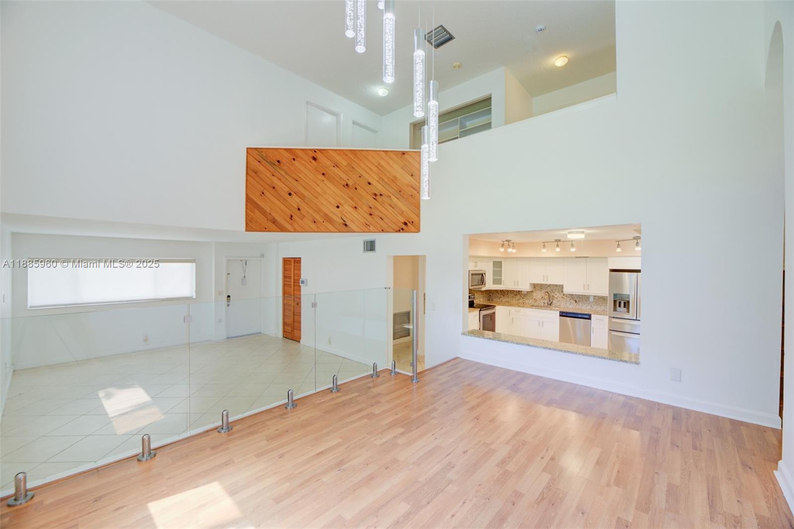 8662 Bridle Path Court, Unit 115A Davie, FL 33328 - Photo 15 of 50 a view of a room with wooden floor and windows