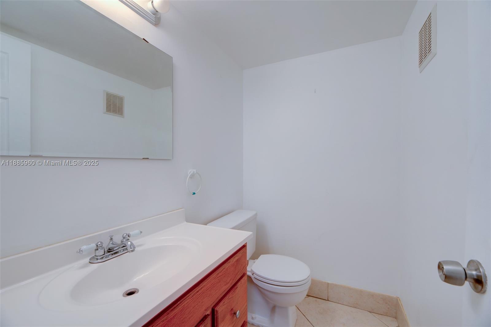 8662 Bridle Path Court, Unit 115A Davie, FL 33328 - Photo 22 of 50 a bathroom with a sink and a toilet