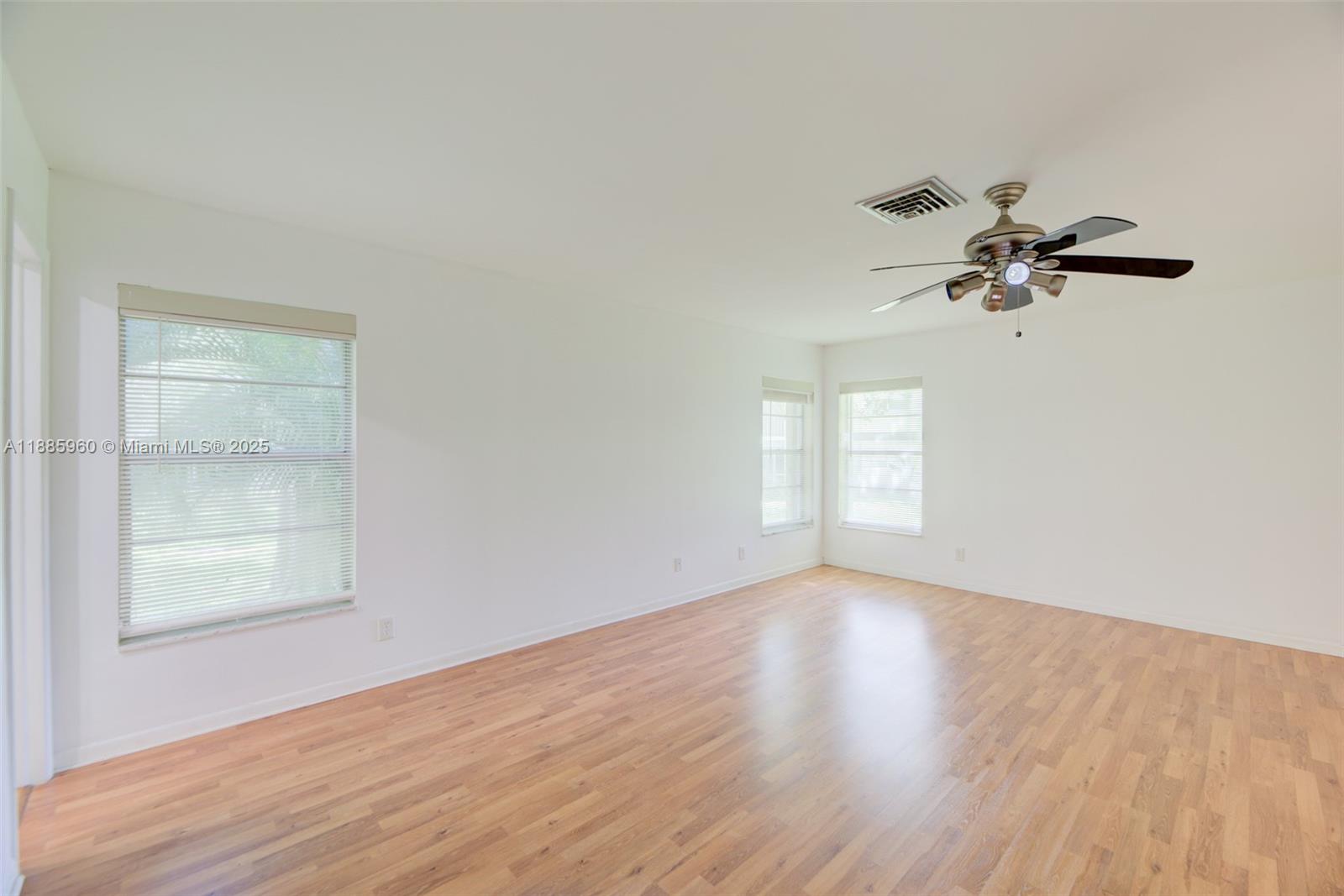 8662 Bridle Path Court, Unit 115A Davie, FL 33328 - Photo 25 of 50 an empty room with a window and a ceiling fan