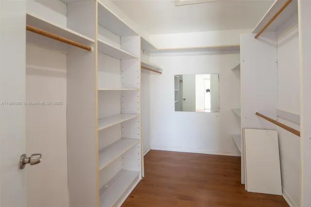 a view of walk in closet with empty racks