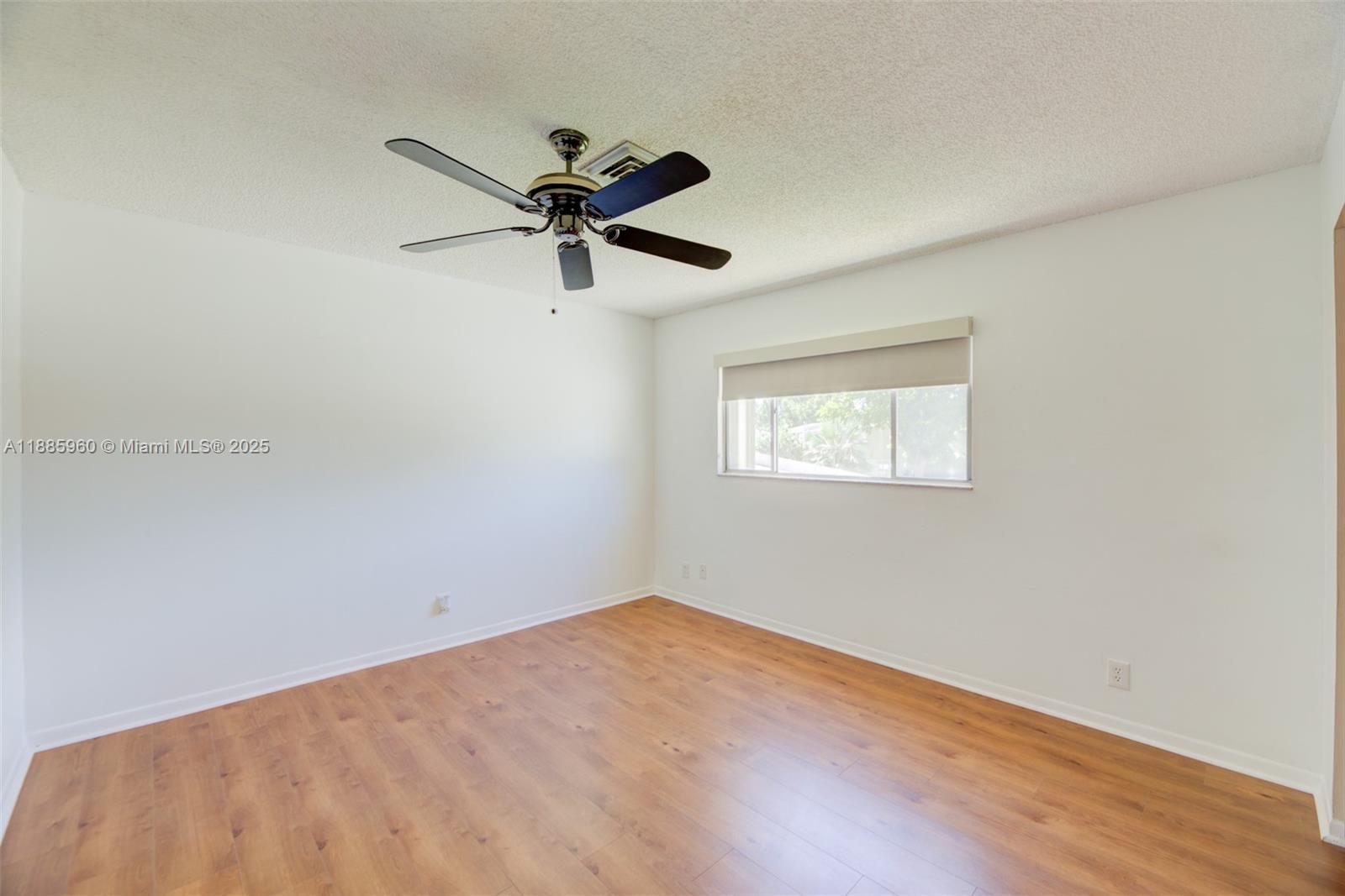 8662 Bridle Path Court, Unit 115A Davie, FL 33328 - Photo 38 of 50 a view of a big room with wooden floor closet and ceiling fan