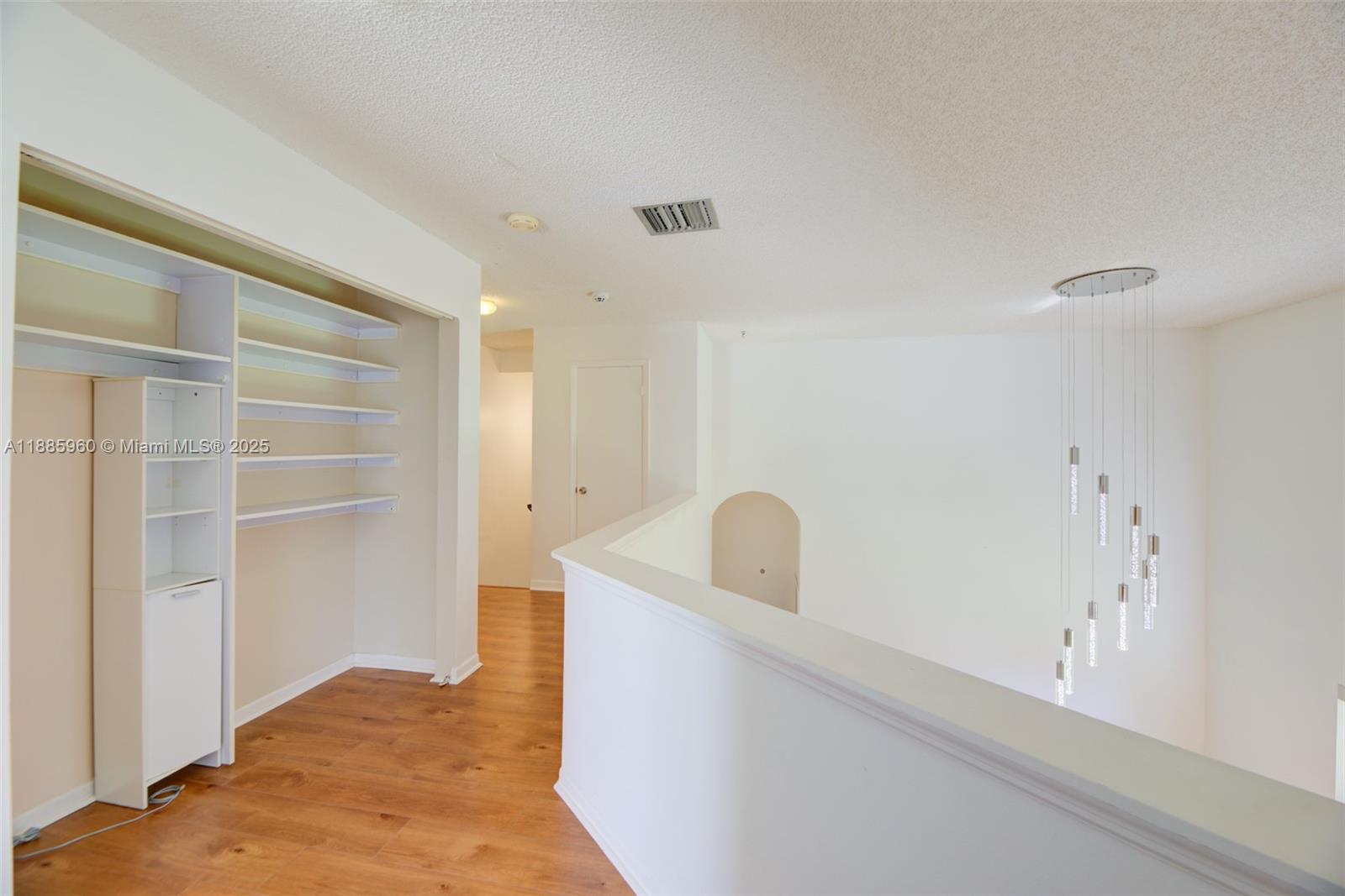 8662 Bridle Path Court, Unit 115A Davie, FL 33328 - Photo 40 of 50 a view of a closet area with empty racks