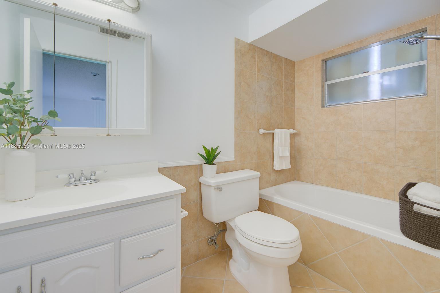 8662 Bridle Path Court, Unit 115A Davie, FL 33328 - Photo 41 of 50 a bathroom with a sink a toilet and shower