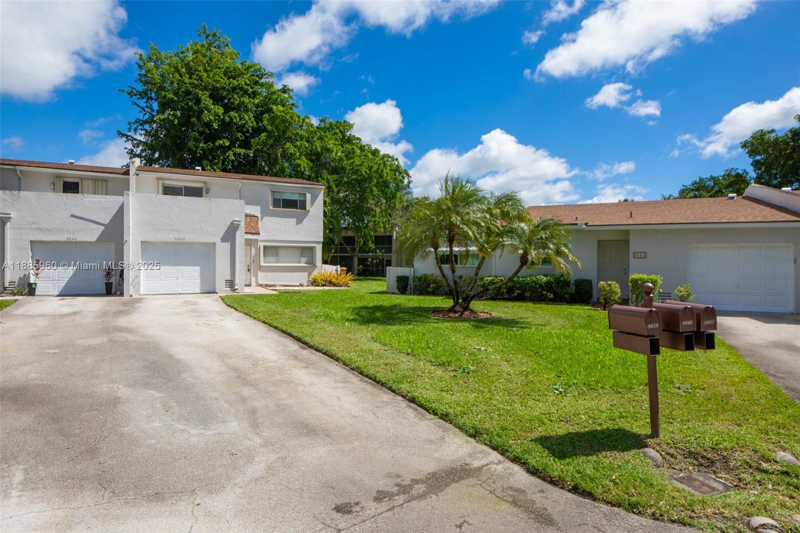 8662 Bridle Path Court, Unit 115A Davie, FL 33328 - Photo 5 of 50 a front view of a house with garden and a tree