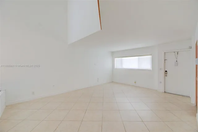 a view of an empty room and a window