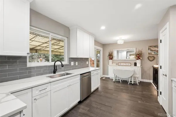 a kitchen with a sink stove and cabinets