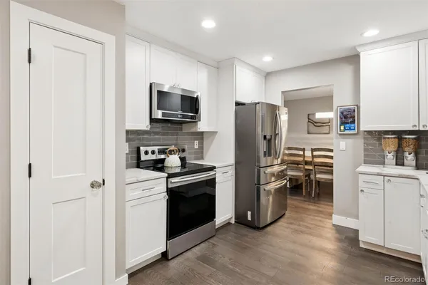 a kitchen with stainless steel appliances a refrigerator stove and microwave