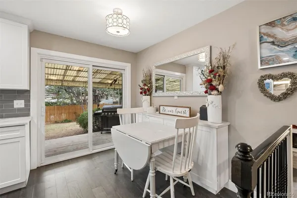 a view of a dining room with furniture large windows and wooden floor