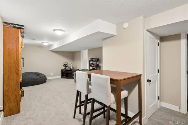 a view of a dining room with furniture and a chandelier