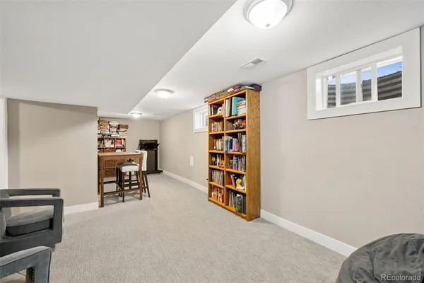 a view of a livingroom with furniture and staircase