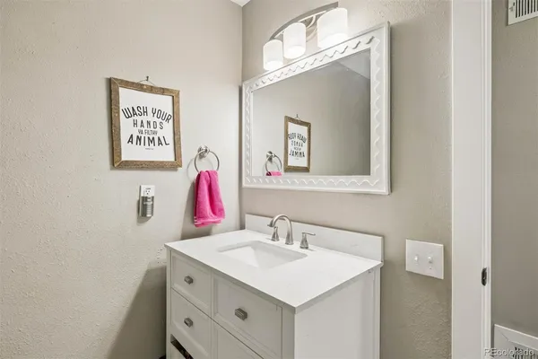 a bathroom with a sink vanity and a mirror