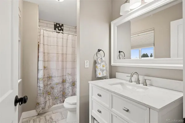 a bathroom with a sink toilet a mirror and shower