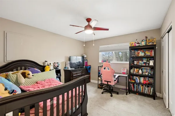 a bedroom with furniture and a book shelf