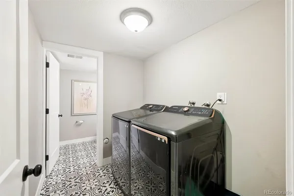 a utility room with a sink dryer and washer