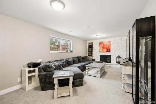 a living room with furniture a large window and a flat screen tv