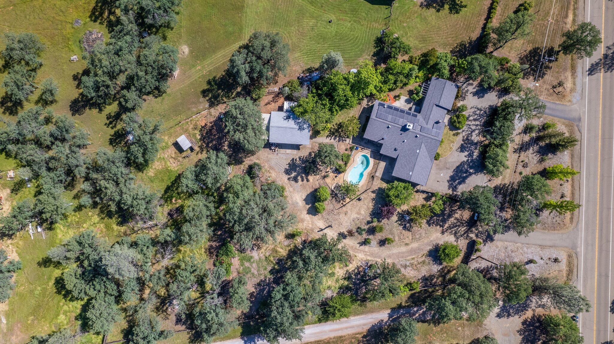 an aerial view of a house with a yard