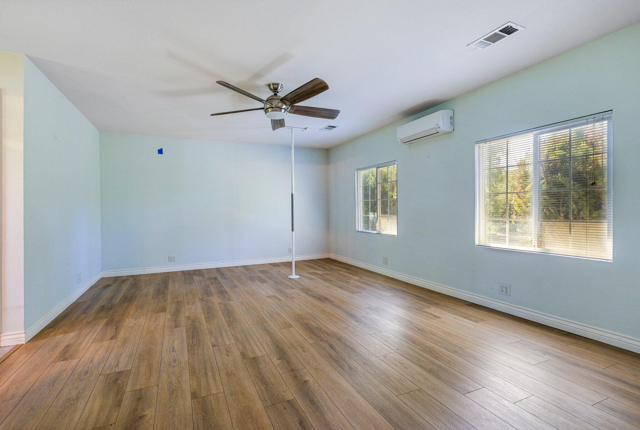 20727 Old Alturas Road Redding, CA 96003 - Photo 14 of 32 a view of empty room with wooden floor and fan
