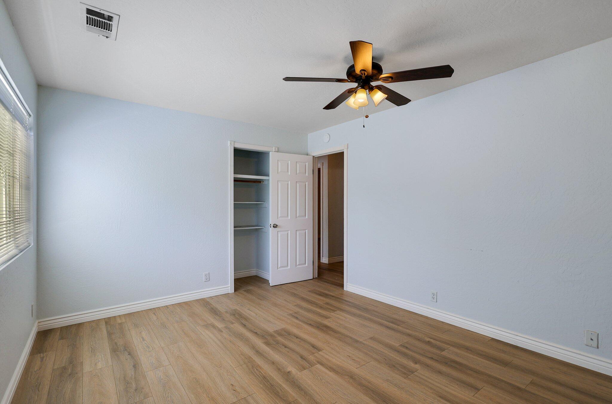 20727 Old Alturas Road Redding, CA 96003 - Photo 18 of 32 a view of empty room with wooden floor and fan