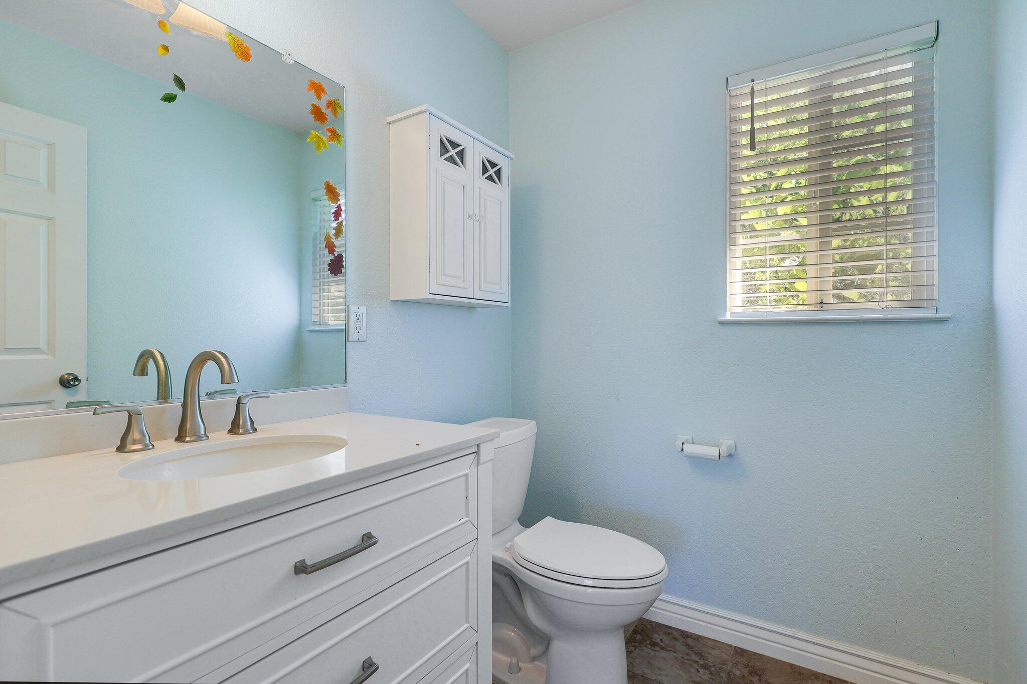20727 Old Alturas Road Redding, CA 96003 - Photo 22 of 32 a bathroom with a sink a toilet and a window