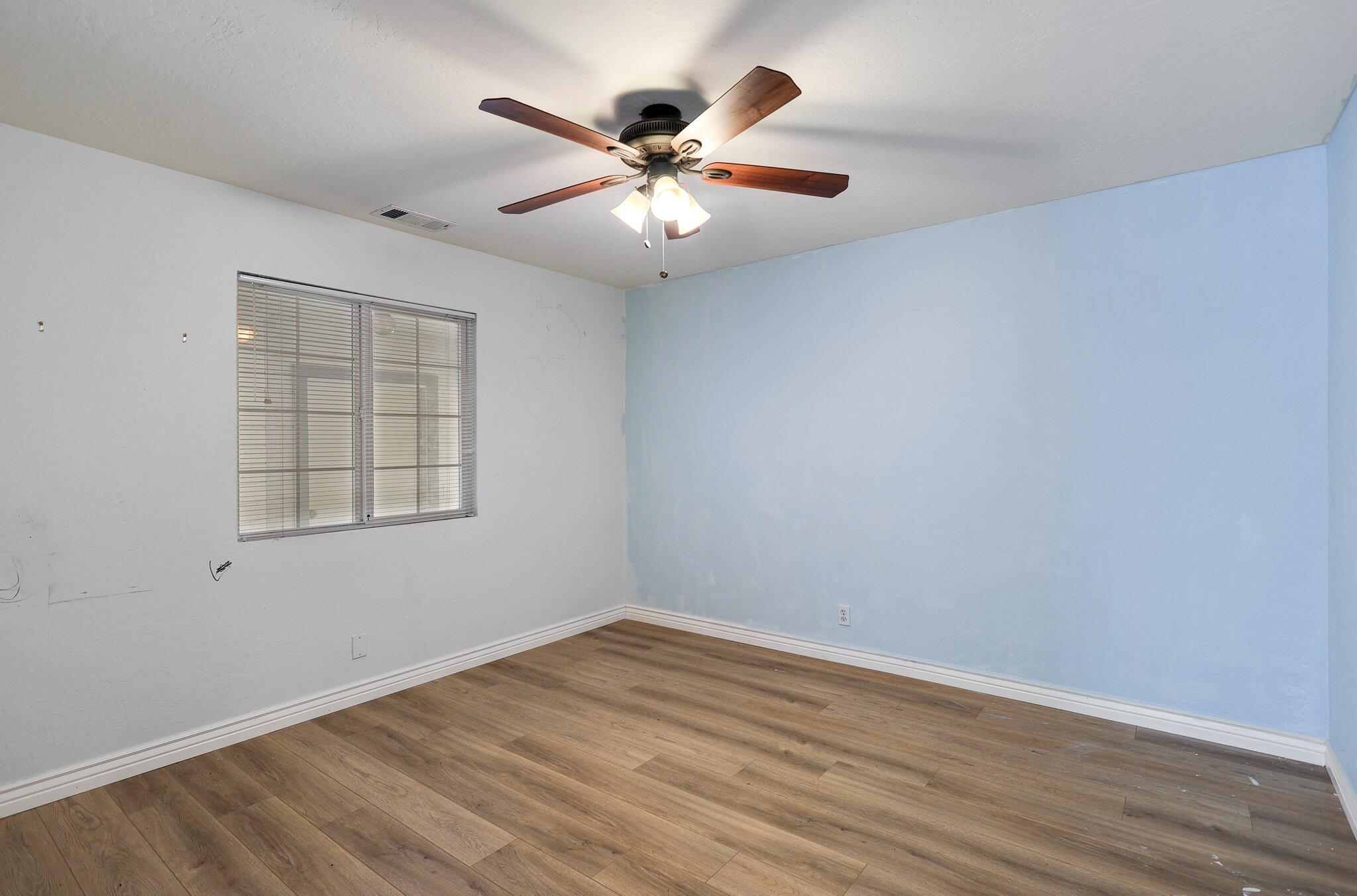 20727 Old Alturas Road Redding, CA 96003 - Photo 23 of 32 wooden floor in an empty room with a window